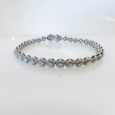 This classic tennis bracelet is made from 14-karat white gold and encrusted with 3.67-carats of diamonds to form the beautiful gift or treat for any occasion. It makes such an elegant choice for a bride to be - especially during the toasts, with a glass of champagne in-hand. - Box fastening - Length: 7 inches - Diamond weight: 3.67 carats ( SI1-2 and G-H color) - Width: Approximately 4.8 mm (measured from the widest part) - Weight: 10.5 grams - Hallmark: none This piece comes with a beautiful je Elegant Silver Tennis Bracelet With Halo Setting, Formal Silver Tennis Bracelet With Halo Setting, Dazzling Platinum Tennis Bracelet With Jubilee Style, Dazzling Platinum Jubilee Tennis Bracelet, Luxury Silver Bracelet With Halo Setting, Classic Formal Tennis Bracelet With Halo Setting, Classic Round Tennis Bracelet With Halo Setting, Classic White Gold Tennis Bracelet With Halo Setting, Elegant Diamond Tennis Bracelet With Halo Setting