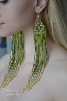 a close up of a woman wearing earrings with beads on it's sides and the back of her neck