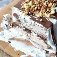 there is a piece of cake on the cutting board with chocolate frosting and nuts