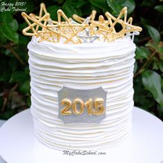 a white cake with gold decorations on top