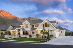 a large white house with mountains in the background