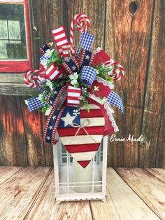 a patriotic lantern with candy canes and flowers