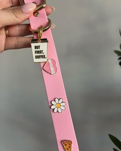 a pink keychain with an ice cream cone and flower on it, but first coffee