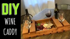 two wine glasses sitting on top of a wooden tray