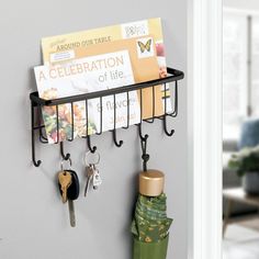 a coat rack with keys and umbrellas hanging from it