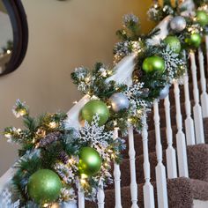 christmas garland on the banisters with green and silver ornaments