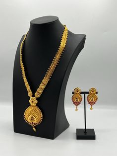 Embrace regal elegance with our exquisite 24K gold-plated Rani Haar set, a true masterpiece designed for the modern queen. This luxurious jewelry set, inspired by traditional royal designs, is perfect for weddings, special occasions, or adding a touch of grandeur to your collection. Care Instructions: To maintain the pristine condition of your Rani Haar set, avoid direct contact with water, perfumes, and harsh chemicals. Store in a dry, cool place when not in use. Luxury Round Temple Necklace As Gift, Ceremonial Hand Set Gold Plated Bridal Necklace, Ceremonial Hand-set Gold Plated Bridal Necklace, Ceremonial Gold-plated Hand Set Bridal Necklace, Traditional Gold Kundan Necklace With Elegant Design, Ceremonial Gold Kundan Necklace, Elegant Meenakari Gold Plated Jewelry Sets, Gold Meenakari Bridal Necklace For Formal Occasions, Gold Traditional Jewelry Sets For Formal Occasions