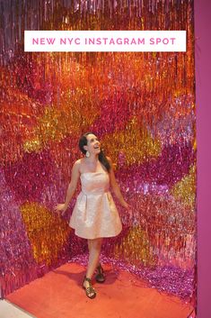 a woman standing in front of a giant display of confetti and streamers