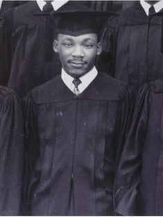 a group of men standing next to each other in graduation gowns