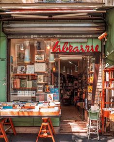 the outside of a book store with tables and chairs