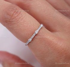 a woman's hand with a diamond ring on it