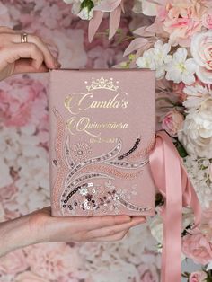 a person holding up a pink book with flowers in the background and text that reads, canada's queeness