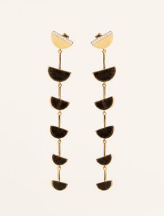 At the crossroads of old-fashioned style and inspirations from other horizons, Seema is a collection that shakes up the lines of femininity. Beyond its remarkable mix of gold and silver, it brings a graphic and modern twist by playing nicely with shapes and curves, all meticulously worked by hand.

 Light and elegant, the Seema earrings in Textured Onyx will enhance your head posture. Hair tied up or down, they will dance with each of your outfits. The Crossroads, Onyx Earrings, Moon Shapes, Half Moon, Gold And Silver, Hair Ties, Shop Earrings, Onyx, 18k Gold