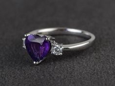 Welcome to my shop, you can find many beautiful gemstone jewelry here, and you also can ask for customized service. Main Stone: 8*8 heart cut natural amethystAccent Stones: czMetal: 925 sterling silver plated with rhodium. I also can provide metal options such as 14k solid yellow/white/rose goldSetting: prong setting More rings please go to my shop home: https://www.etsy.com/shop/XCjewelryStudio?ref=hdr_shop_menuIt's a perfect gift for the person who was born in February (Birthstone), it's quite Elegant Purple Heart Promise Ring, Fine Jewelry Purple Amethyst Ring For Valentine's Day, Purple Amethyst Heart Cut Ring For Valentine's Day, Amethyst Heart Ring For Wedding And Valentine's Day, Amethyst Heart Ring For Valentine's Day Wedding, Purple Heart Cut Heart Ring As Gift, Valentine's Day Purple Amethyst Promise Ring, Valentine's Day Wedding Heart Amethyst Ring, Wedding Amethyst Heart Ring With Gemstone