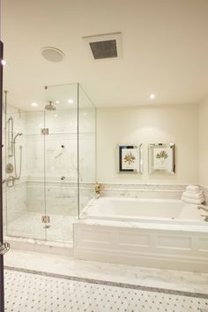 a bathroom with a large tub and walk in shower