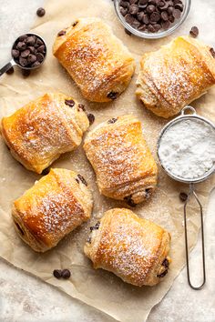 chocolate chip pastries with powdered sugar on parchment paper