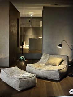 a modern living room with grey walls and wooden floors