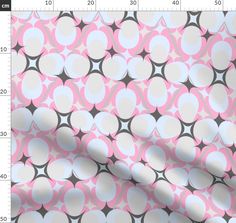 a pink and grey pattern with circles on it, as well as a ruler for measurements