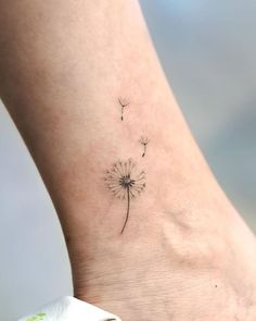 a small dandelion tattoo on the ankle