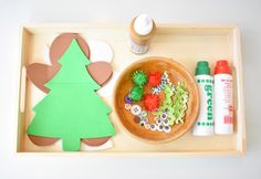 a tray with some crafting supplies on it and a paper christmas tree in the middle