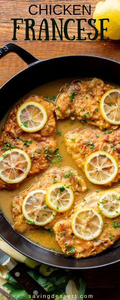 chicken with lemons and parsley in a skillet on a table next to sliced lemons