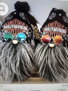 two hats with sunglasses on top of each other in front of a stuffed animal toy