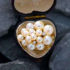 This scrumptious vintage cluster ring features an organic design that is post set with fifteen (15) saltwater Akoya pearls, and four (4) prong set round brilliant cut diamond accents. The ring measures 18.3mm at the top, rises 14.9mm above the finger, tapering to 3.5mm wide and 1.7mm thick at the base of the shank. It is crafted in 18k yellow gold and is currently a size 4.5. Fine Jewelry Cluster Pearl Ring For Anniversary, Fine Jewelry Pearl Cluster Ring For Wedding, Elegant Cluster Pearl Ring Gift, Elegant Cluster Pearl Ring As A Gift, Cluster Pearl Wedding Ring, Anniversary Fine Jewelry Pearl Cluster Ring, Wedding Pearl Cluster Ring, Wedding Cluster Pearl Ring, Multi-stone Diamond Pearl Ring For Wedding