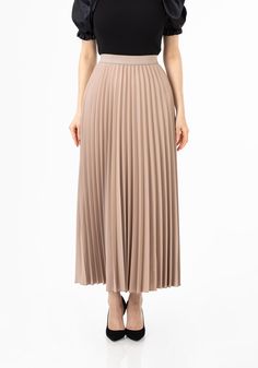 Mink Colored Pleated Maxi Skirt: Flowy, Elegant and Comfortable Add some elegance to your wardrobe with our Mink Pleated Maxi Skirt. Crafted from a lightweight woven fabric with 11% elastane, this skirt features a comfortable elastic waistband and a flowing pleated design that provides more room around the hemline, allowing you to feel the breeze while maintaining modesty. With its ankle-length style and pull-up waistband, this skirt is perfect for pairing with blouses and loose tops for a versa Office Skirts, Mink Colour, Ankle Length Skirt, Pleated Maxi Skirt, Color Pairing, Pleated Maxi, Perfect Wardrobe, Fall Skirts, Loose Tops