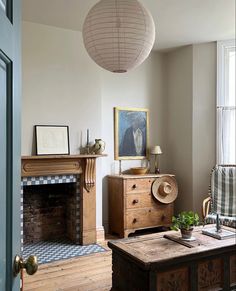 a living room filled with furniture and a fire place in front of a painting on the wall