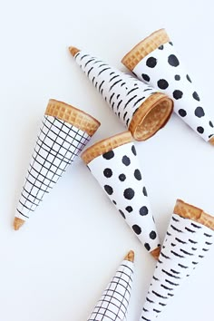 four cones made out of waffles with black and white polka dots on them