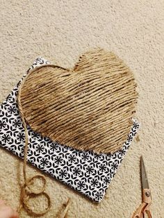 a heart shaped piece of jute next to scissors