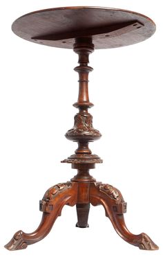 an old wooden table with carvings on the top and bottom, sitting in front of a white background