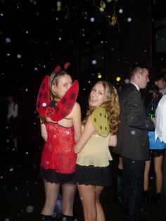 two women dressed up as ladybugs in the rain