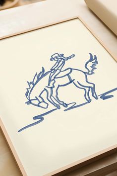 a drawing of a man riding a horse on a white paper with blue ink in it