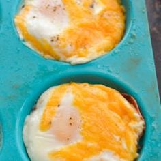 three eggs in a muffin tin on a table