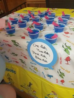 a table topped with blue cups filled with water