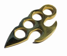 two brass colored scissors with holes in the middle, on a white background and there is no image here to provide a caption for