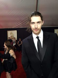 a man in a tuxedo posing for the camera