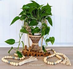 a potted plant sitting on top of a table next to beads and wooden beads