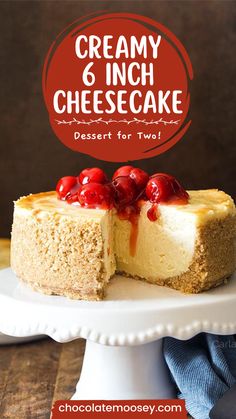 a cheesecake with cherries is on a white cake platter and has the title creamy 6 inch cheesecake dessert for two