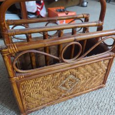 an old bamboo basket is sitting on the floor