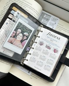 an open planner book with photos on it