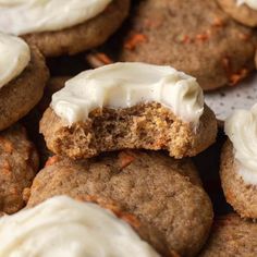 some cookies with white frosting and carrots on top