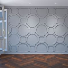 an empty room with white walls and wood flooring on the wall is decorated with circles