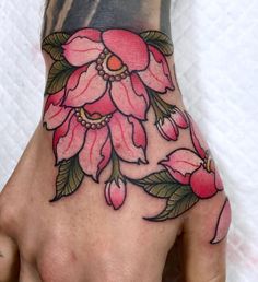 a woman's hand with pink flowers on it