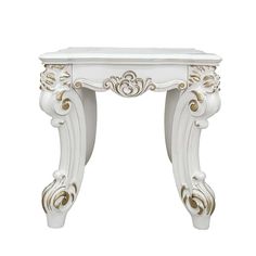 a white table with gold accents on the top and bottom edge, against a white background