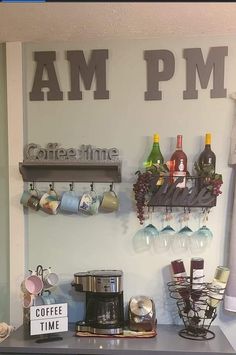 there is a coffee maker and cups on the counter in front of the sign that says i am pm