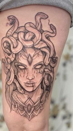 a woman with snakes on her head is shown in this black and white tattoo design