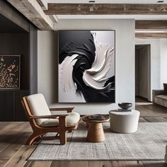 a living room filled with furniture and a large painting on the wall above two chairs