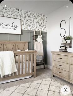 a baby's room with a crib, dresser and changing table in it